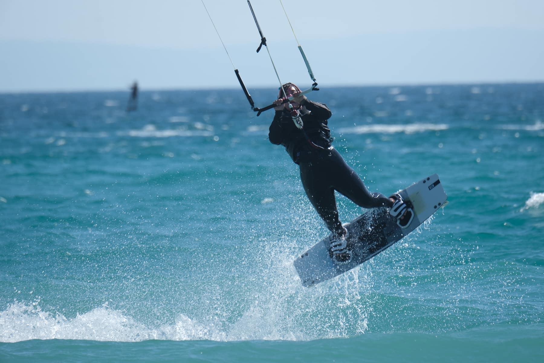 Kitesurfer riding in blue water in Tarifa
