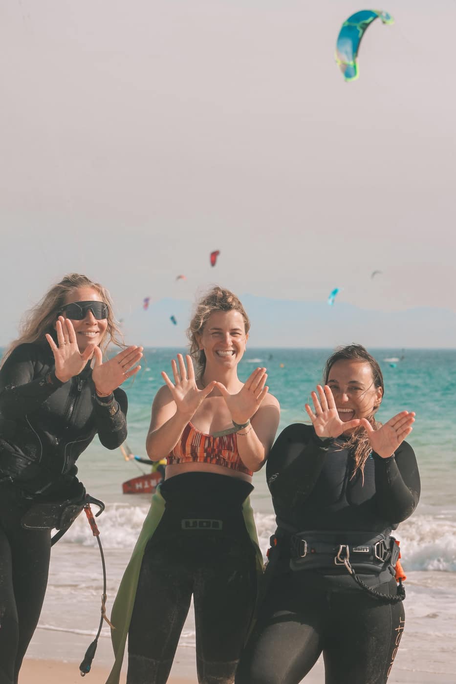 Three women smiling on Tarifa beach