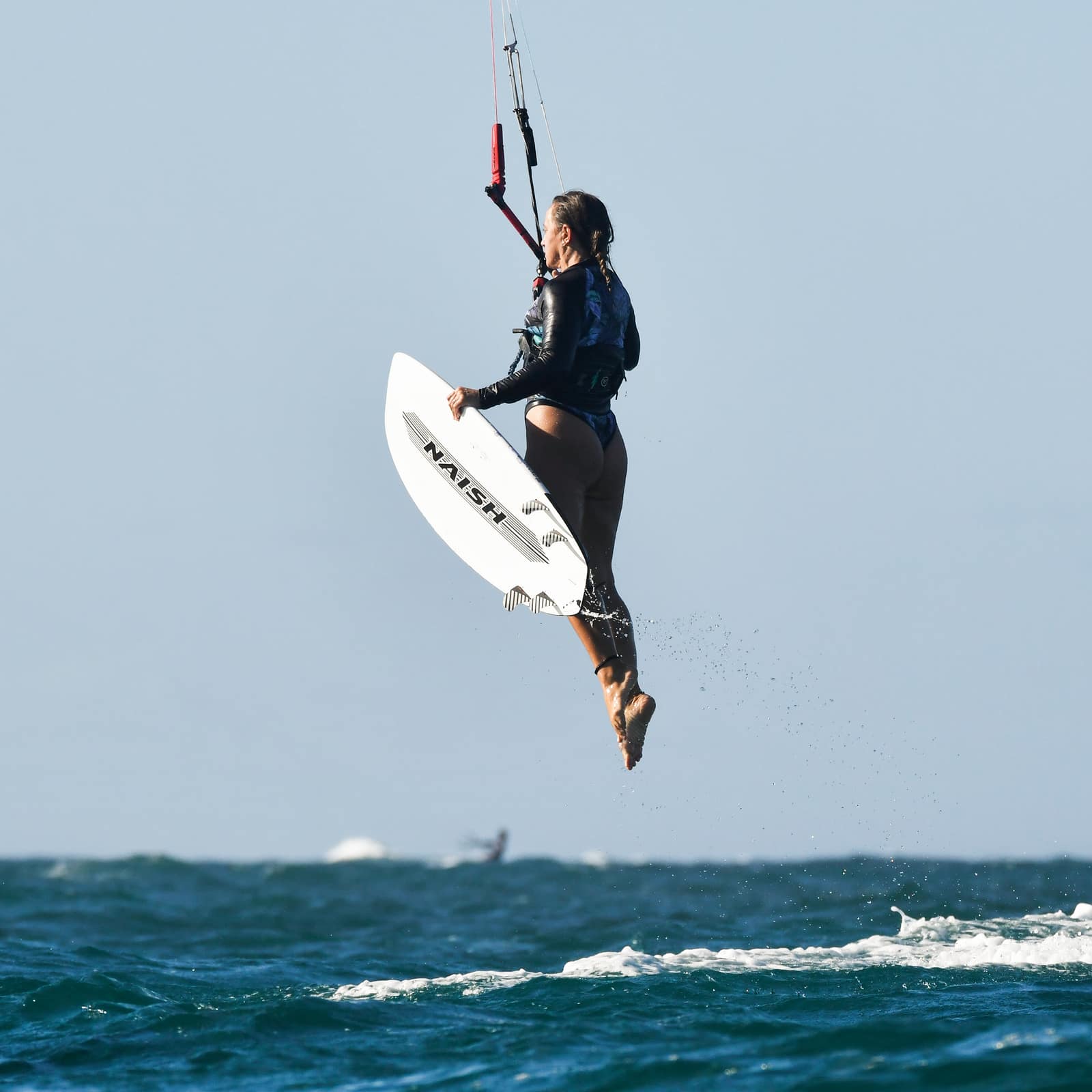 Moni riding on the water during a kite session