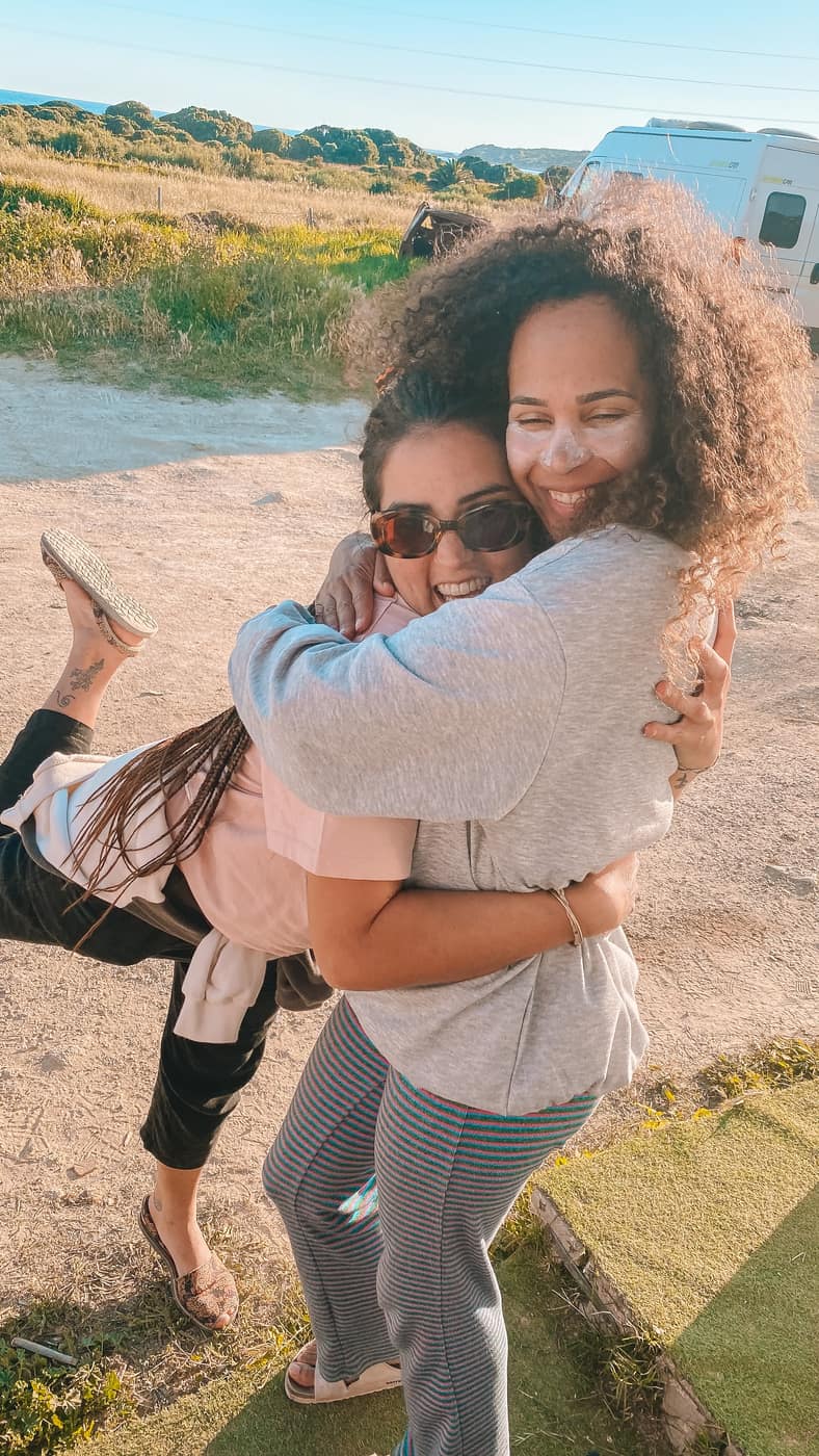 Two women hugging and smiling during a WeGirls trip
